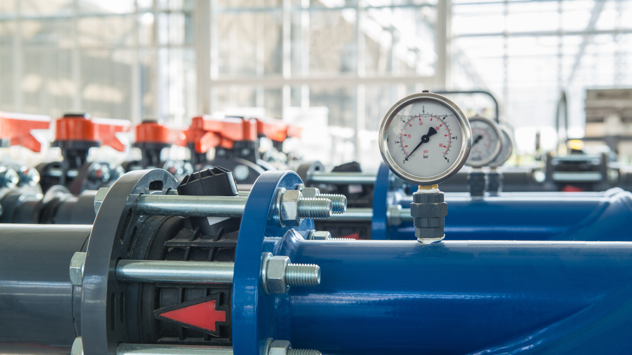 Industrial pipeline system with pressure gauge, representing crankshaft applications in fluid control systems.
