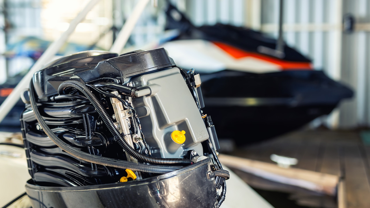 Outboard motor engine mounted on boat, illustrating crankshaft use in marine propulsion systems.